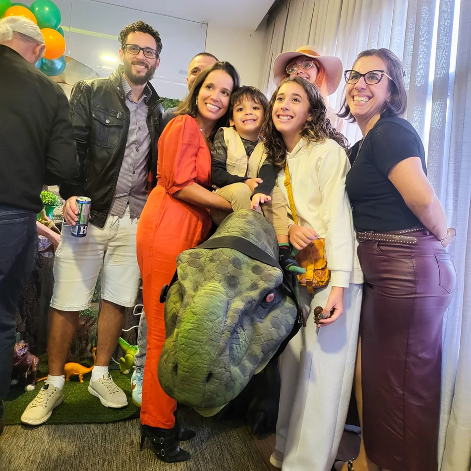 Atriz exploradora interagindo com dinossauro baby em evento infantil em Salto